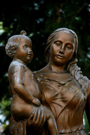 mata de sao joao, bahia / brazil - november 8, 2020: statue of a mother holding her son in a public square in the city of Mata de Sao Joao.のeditorial素材