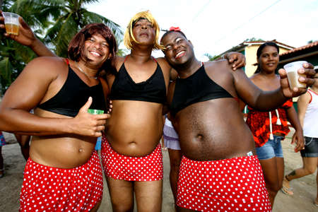 camamu, bahia, brazil - february 19, 2012: men dressed as women participate in the carnival party of Ilha Grande, in Camamu bay, south of Bahia.のeditorial素材