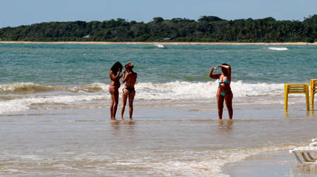 porto Seguro, bahia / brazil - january 7, 2011: people are seen sitting next to chairs on the beach of Trancoso in the city of Porto Seguro, in the south of Bahia.のeditorial素材