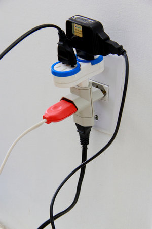 salvador, bahia / brazil - november 10, 2013: household electrical outlet is seen with several plugged power cables, situation of risk of short circuit.のeditorial素材
