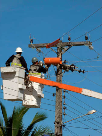 prado, bahia / brazil - december 9, 2009: electricians are seen making repairs to a utility pole in the city of Prado.のeditorial素材