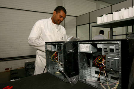 ilheus, bahia / brazil - june 13, 2011: workers are seen on a computer assembly line in a factory at the Informatics Pole in the city of Ilheus, in southern Bahia.のeditorial素材