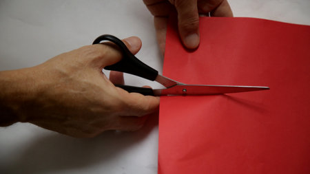 hand holds scissors during papal court.の写真素材
