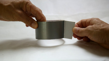hand opening adhesive tape on a roll.の写真素材