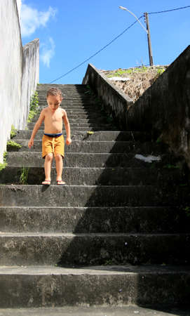 salvador, bahia / brazil - july 2, 2020: child is seen climbing stairs in residential condominium in the city of Salvador.のeditorial素材