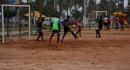salvador, bahia / brazil - april 21, 2013: people are seen playing soccer on a dirt field neighborhood of Boca do Rio in the city of Salvador.のeditorial素材