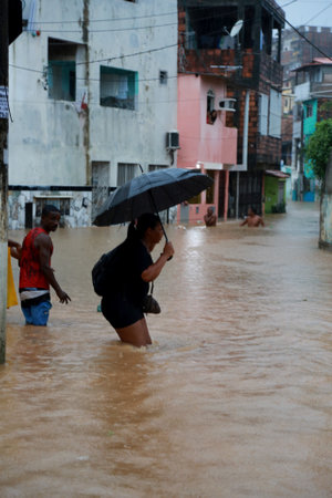 salvador, bahia / brazil - april 27, 2015: people are seen in flooded area due to rain in the Narandiba neighborhood in the city of Salvador.のeditorial素材