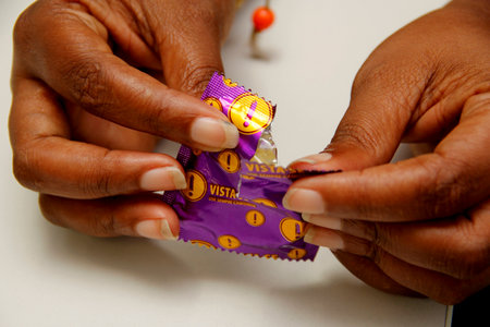 salvador, bahia / brazil - february 6, 2013: hand holds male condom, contraceptive method and also used to control sexually transmitted diseases.のeditorial素材