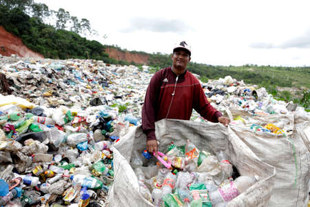 catu, bahia / brazil - may 2, 2019: person is seen collecting material for recycling at the landfill...