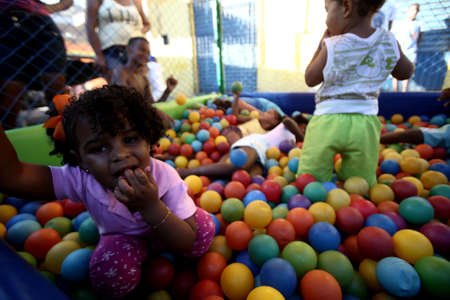salvador, bahia / brazil - october 15, 2017: Children play in pool during Children's Day party held by residents of Alagados neighborhoods in Massaranduba in the city of Salvador.のeditorial素材