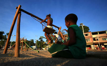 salvador, bahia / brazil - december 1, 2015: Children are seen playing on a playground in the Sao Tome de Paripe neighborhood in the city of Salvador.のeditorial素材