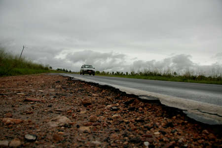 porto Seguro, bahia / brazil - may 5, 2009: shoulder devastated by the erosion on the highway BR 367 in the city of Porto Seguro, in the south of Bahia.のeditorial素材