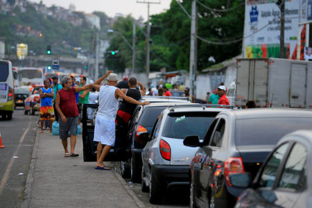 itaparica, bahia / brazil - june 24, 2014: vehicles are seen in line to board the ferry boat on the island of Itaparica for crossing to Salvador.のeditorial素材