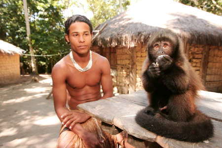 Porto Seguro, Bahia / Brazil - June 18, 2010: Pataxo Indians hold pet monkeys in Vila Jaquira in the...
