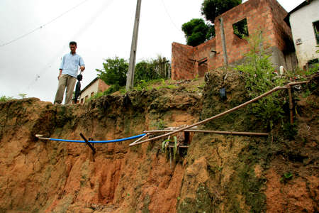 porto Seguro, bahia / brazil - december 1, 2008: destruction of asphalt on the road, caused by erosion of rainwater in the city of Porto Seguro, in southern Bahia.のeditorial素材
