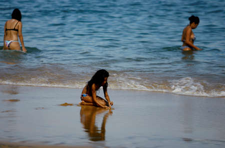 salvador, bahia / brazil - december 29, 2013: People are seen at Porto da Barra beach in the city of Salvador.のeditorial素材