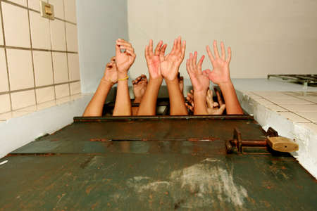 teixeira de freitas, bahia / brazil - november 6, 2010: hands of adolescent offenders are seen in prison in the city of Teixeira de Freitas.のeditorial素材