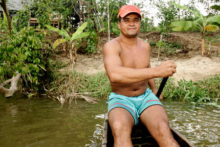 eunapolis, bahia / brazil - july 8, 2009: fisherman is seen in the waters of the Buranhem river in the city of Eunapolis, in southern Bahia.のeditorial素材