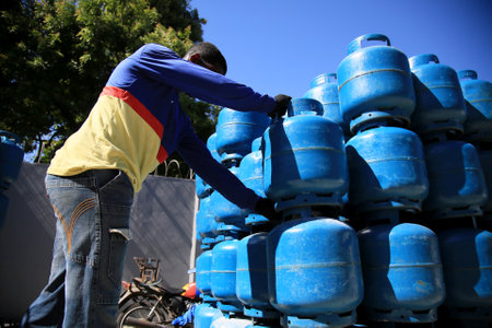 salvador, bahia / brazil - december 17, 2019: Worker is seen near the LPG gas canister in the Cabula neighborhood of Salvador.のeditorial素材