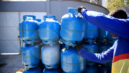 salvador, bahia / brazil - december 17, 2019: Worker is seen near the LPG gas canister in the Cabula neighborhood of Salvador.のeditorial素材