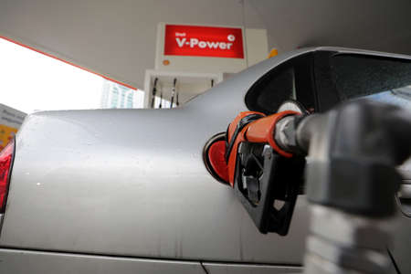 salvador, bahia / brazil - august 7, 2019: Gas station attendant making fuel supply in vehicle at...