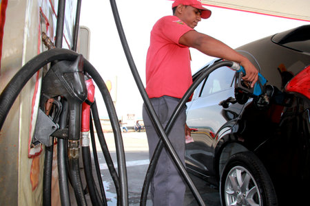 salvador, bahia / brazil - december 10, 2012: gas station attendant supplies gasoline at gas stations in the Petrobras network in the city of Salvador.のeditorial素材