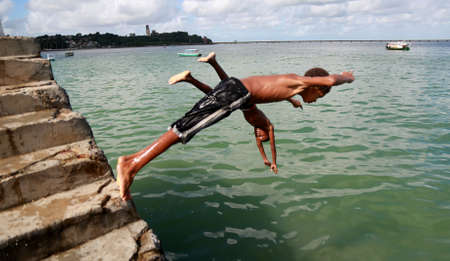 salvador, bahia / brazil - june 5, 2015: Young people are seen jumping from the boats pier in Sao Tome de Paripe, suburb of Salvador.のeditorial素材