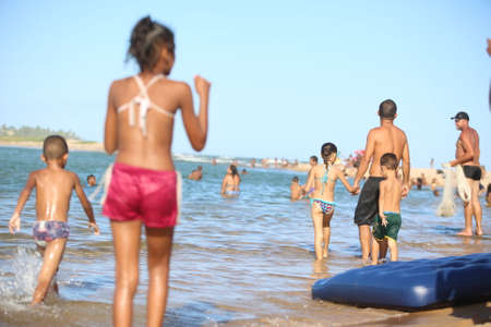 lauro de freitas, bahia / brazil - january 16, 2017: people are seen at the mouth of the Joanes River in the neighborhood of Buraquinho, in the city of Lauro de Freitas.のeditorial素材