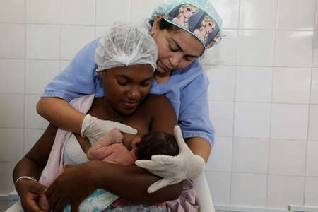 alagoinhas, bahia / brazil - September 10, 2019: nurse teaches mother to breastfeed her baby in a maternity hospital in Alagoinhas.のeditorial素材