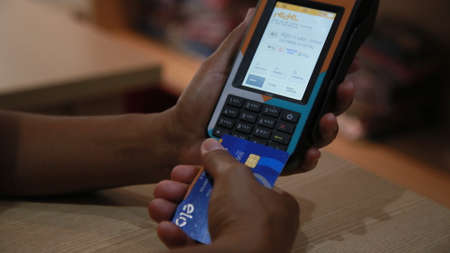 salvador, bahia / brazil - november 22, 2019: person uses credit card machine in shoppng shop in the city of Salvador.のeditorial素材