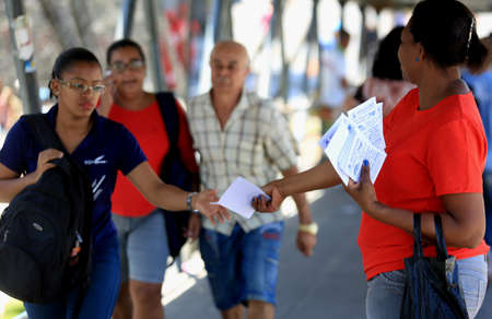 salvador, bahia / brazil - november 12, 2015: person is seen distributing advertising pamphlet in...