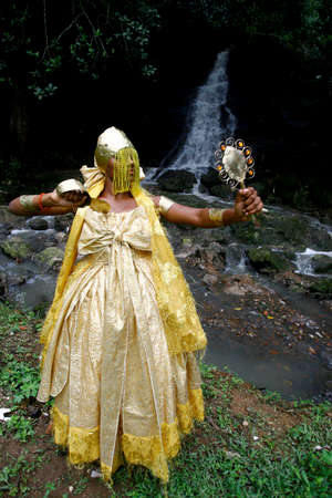 salvador, bahia / brazil - outobro 4, 2014: young man is seen at Parque Sao Bartolomeu in Salvador, wearing costumes from the orixa Oxum, a Candomble entity that reigns in fresh waters.のeditorial素材