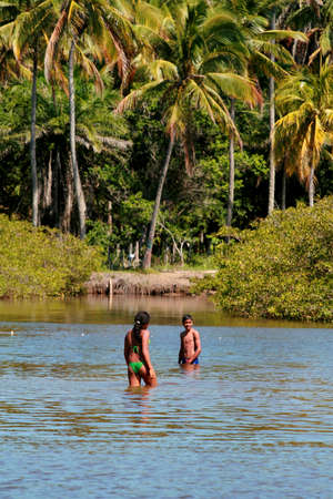 santa cruz cabralia, bahia / brazil - july 26, 2008: people play in the water of the Guaiu River in the Santo Andre district in Santa Cruz Cabralia.のeditorial素材