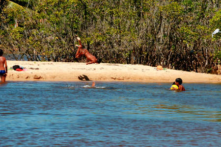santa cruz cabralia, bahia / brazil - july 26, 2008: people play in the water of the Guaiu River in the Santo Andre district in Santa Cruz Cabralia.のeditorial素材