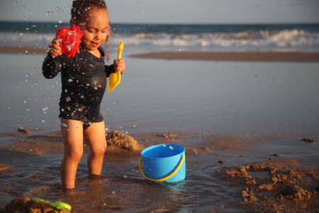 alvador, bahia / brazil - february 27, 2017: Child is seen playing on Pituacu Beach in Salvador.のeditorial素材