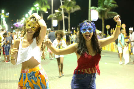 salvador, bahia / brazil - february 8, 2018: people sweat masks and costumes in the Barra neighborhood during the carnival in the city of Salvador.のeditorial素材