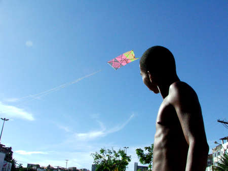 salvador, bahia / brazil - november 18, 2006: young man is seen flying a kite on Avenida Vasco da Gama in the city of Salvador.のeditorial素材