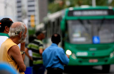 salvador, bahia / brazil - september 22, 2016: Senior citizen is seen waiting for public transportation bus from Salvador city.