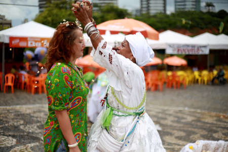 salvador, bahia / brazil - january 25, 2015: Candomble fans are seen during a bath with popcorn in...