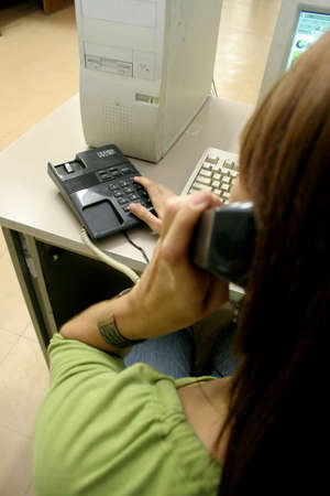 salvador, bahia / brazil - june 30, 2006: a person is seen using a fixed telephone in an office in the city of Salvador.のeditorial素材