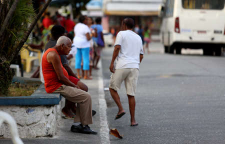 salvador, bahia / brazil - october 25, 2016: Elderly man is seen sitting at the bus terminal in Barroquinha in the city of Salvador.のeditorial素材