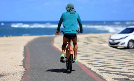 salvador, bahia / brazil - august 3, 2016: cyclist is seen on bike path in the city of salvador.のeditorial素材