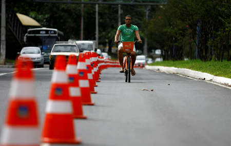 salvador, bahia / brazil - august 10, 2014: cyclist uses bike lane in the neighborhood of Itaigara in Salvador, reserved for physical activities on weekends.のeditorial素材