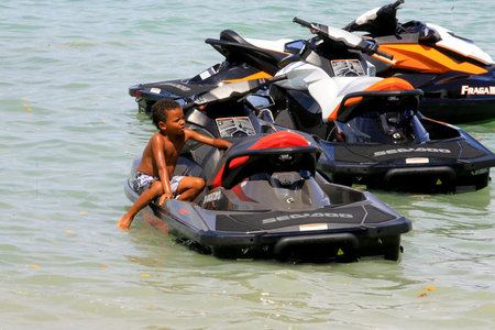 cairu, bahia / brazil - november 14, 2013: child is seen next to water bikes in Morro de Sao Paulo.のeditorial素材