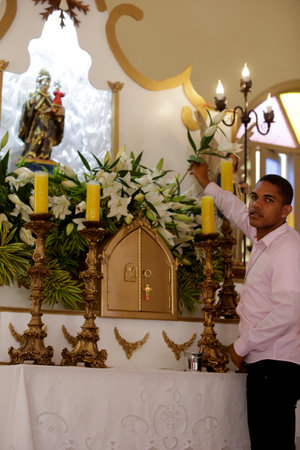 lauro de freitas, bahia / brazil - june 5, 2019: devotee of Santo Antonio prepares celebration at...