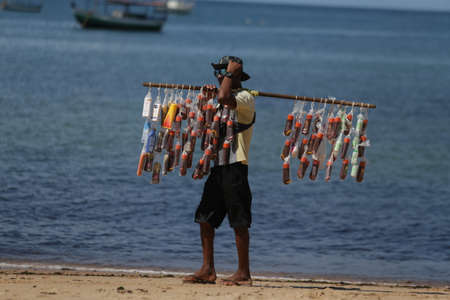 salvador, bahia / brazil - january 21, 2019: seller of sunscreens seen at Itapua beach in Salvador.のeditorial素材