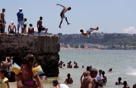 salvador, bahia / brazil - january 1, 2015: Young man is seen jumping from platform at Boa Viagem beach in Salvador.のeditorial素材