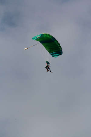itaparica, bahia / brazil - august 18, 2012: person is seen during a parachute jump on the island of...