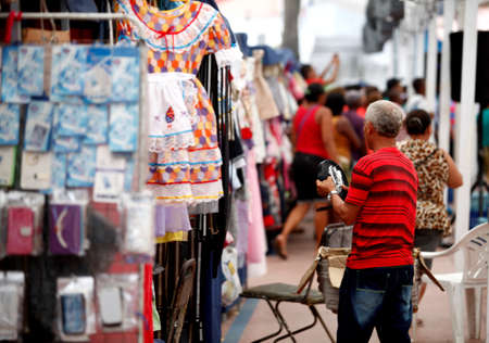 salvador, bahia / brazil - may 16, 2016: Clothing seller is spotted in Conmercio Street location in the Baixa dos Sapateiros region in Salvador city. *** Local Caption ***のeditorial素材
