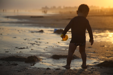 alvador, bahia / brazil - january 6, 2018: Child is seen playing on Pituacu Beach in the city of Salvador.のeditorial素材